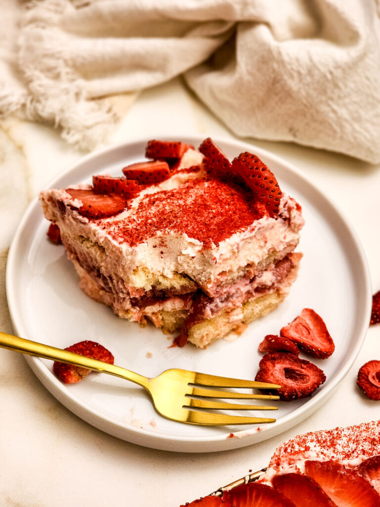 Strawberry Tiramisu - Imagine layers of juicy strawberries simmered with lemon, delicate ladyfingers dipped in strawberry milk, and clouds of mascarpone cream, all crowned with a dusting of vibrant freeze-dried berries. It’s a playful, sun-kissed twist on the classic Italian dessert, and every bite tastes like the start of summer.