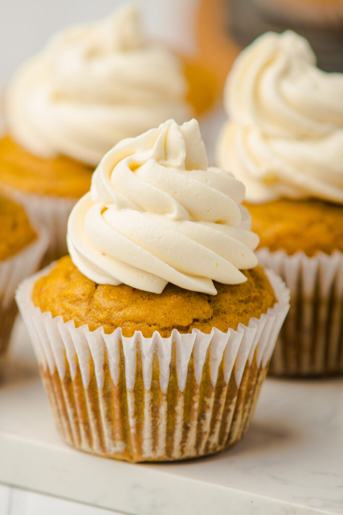 Pumpkin Recipes | Pumpkin Desserts | Pumpkin Muffins | If you’re searching for a cozy, wholesome treat to celebrate pumpkin season, these Flourless Pumpkin Muffins are just the ticket! Made with almond flour and naturally sweetened with honey, they’re perfectly moist, warmly spiced, and entirely gluten-free—so everyone at your table can enjoy a bite. With a dollop of tangy cream cheese frosting on top (totally optional, but highly recommended!), these muffins are the ultimate fall comfort food.