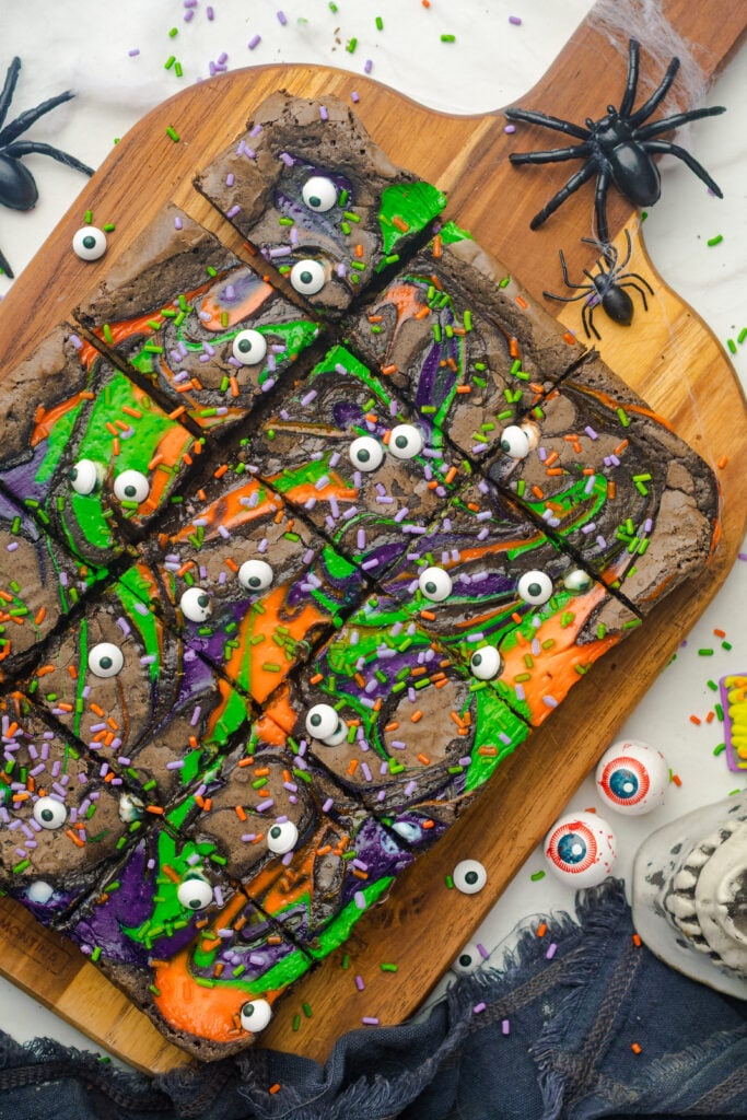 Halloween Cream Cheese Swirl Brownies | These brownies are simple to put together but make a big impression with their colorful cream cheese swirls and deep chocolate flavor. Using real dark chocolate and a touch of cocoa gives them a fudgy texture, while the cream cheese adds a creamy contrast in every bite.