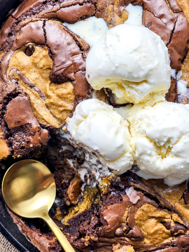 Pumpkin Brookie Skillet | Fudgy brownies meet pumpkin spice in this gooey skillet brookie—swirled with chocolate chips and bursting with cozy fall flavor!