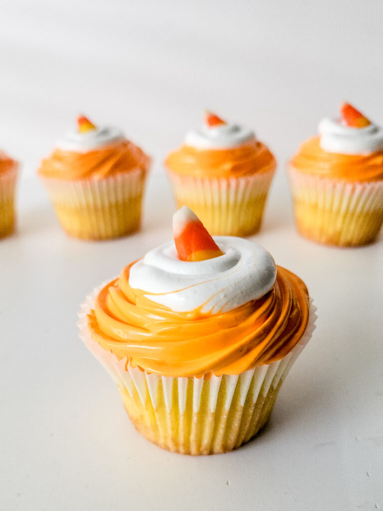 Celebrate Halloween with these festive Candy Corn Cupcakes! Moist vanilla cake is tinted yellow, then topped with fluffy orange marshmallow frosting for a treat that’s as cute as it is delicious. Perfect for parties, baking with kids, or sharing spooky season cheer!