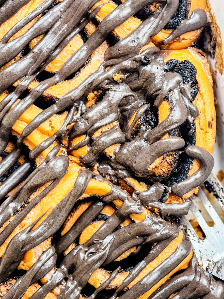 Soft cinnamon rolls with Oreo filling and black cocoa frosting, a spooky-sweet Halloween magic in every cozy bite.