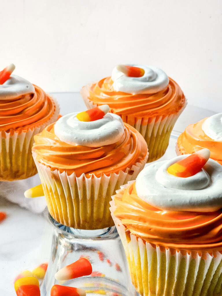Celebrate Halloween with these festive Candy Corn Cupcakes! Moist vanilla cake is tinted yellow, then topped with fluffy orange marshmallow frosting for a treat that’s as cute as it is delicious. Perfect for parties, baking with kids, or sharing spooky season cheer!